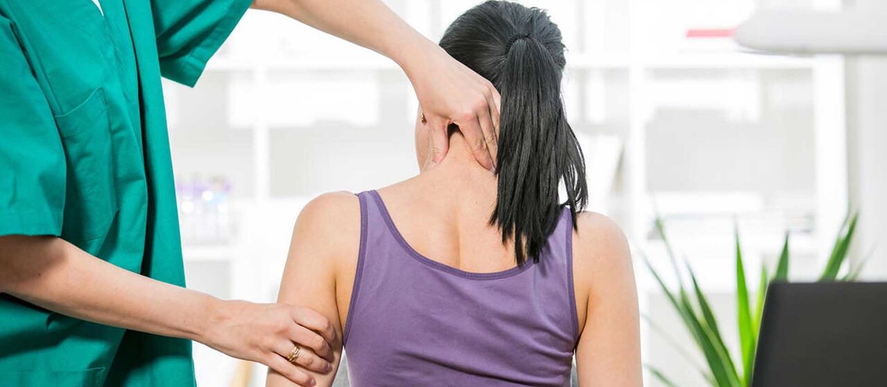 Patient with neck pain being examined by doctor